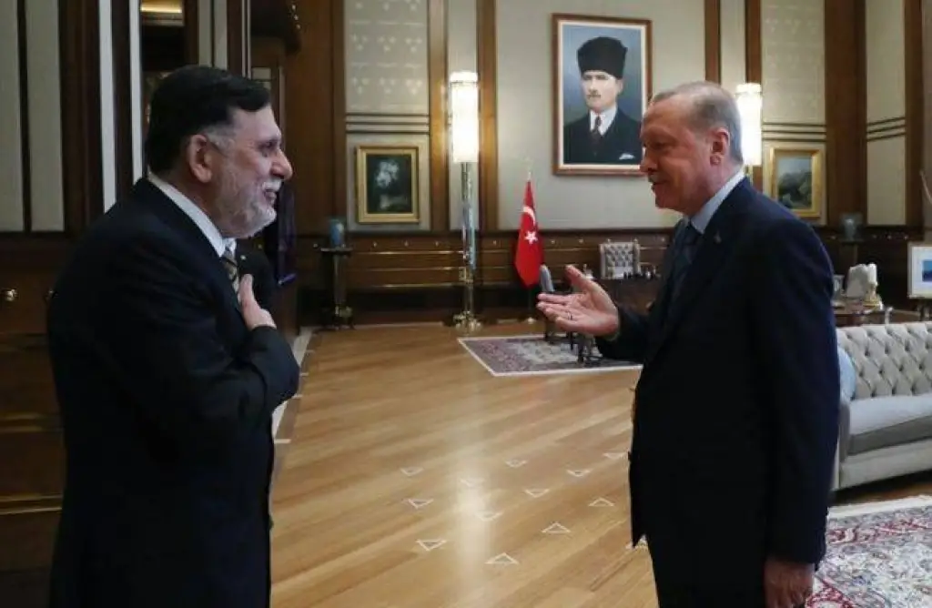 أردوغان يعلق على لحية السراج.. ويشير بيده إلى لوحتين (فيديو)